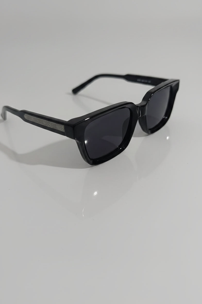 Black sunglasses on a white surface