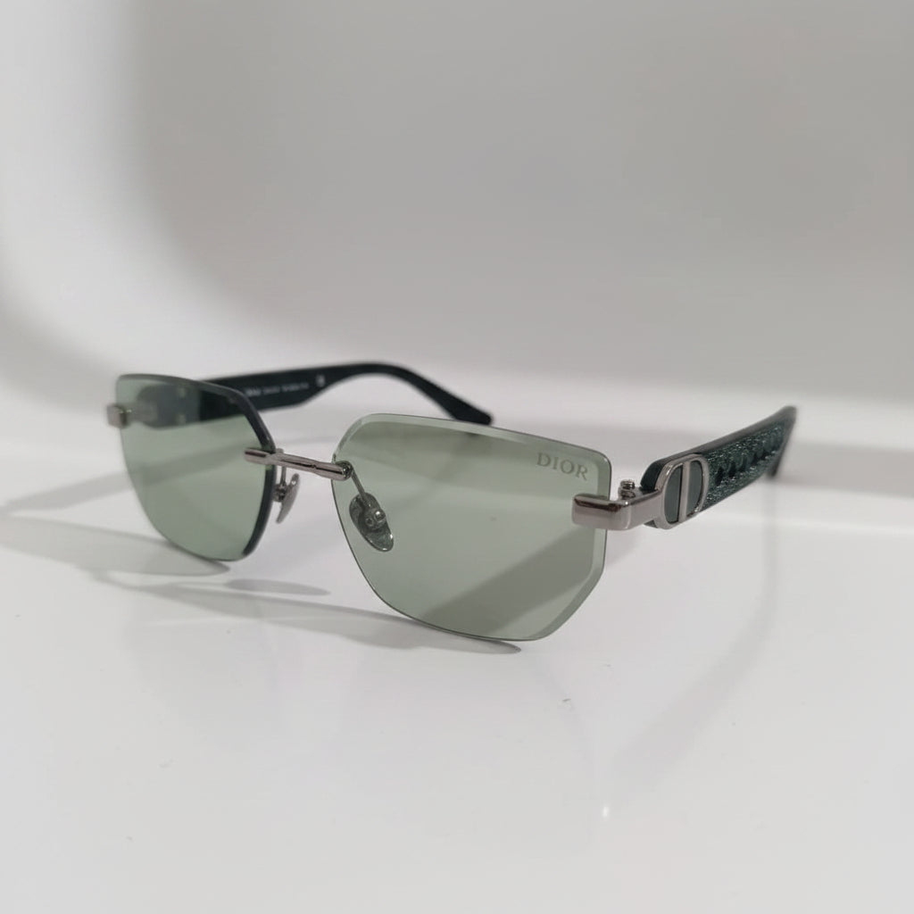 Sunglasses with a Dior logo on a white surface