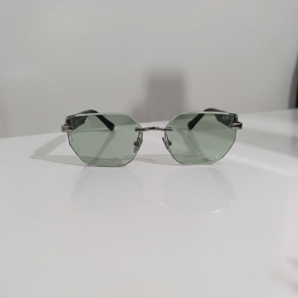 Sunglasses with green lenses on a white surface
